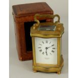 A 19thC French brass carriage timepiece, with white dial, and roman numerals, marked Stewart & Co