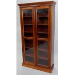 A Victorian mahogany bookcase, the top with a moulded cornice above two glazed doors enclosing