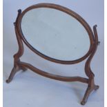 A 20thC mahogany swing frame mirror, with an oval plate, on shaped supports,51cm wide (M)