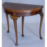 A 1920's figured walnut demi-lune card table, the top with crossbanded border, on cabriole legs,