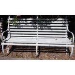 A late 19thC railway or park type garden bench, with three wrought iron supports and white painted