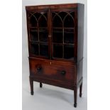 A mahogany and ebony strung bookcase, the top with two astragal glazed doors enclosing shelves,