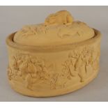 A 19thC Wedgwood caneware game pie dish, with rabbit finial, moulded with grapevines, game etc.,