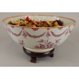 An early 19thC Chinese export bowl, decorated in European style with flowers, sprays and swags in