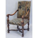 A late 19th/early 20thC Continental walnut open armchair, with tapestry padded back and seat, on