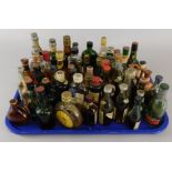 A collection of 20thC bottles of liqueurs, whiskeys etc. (AF) (M)