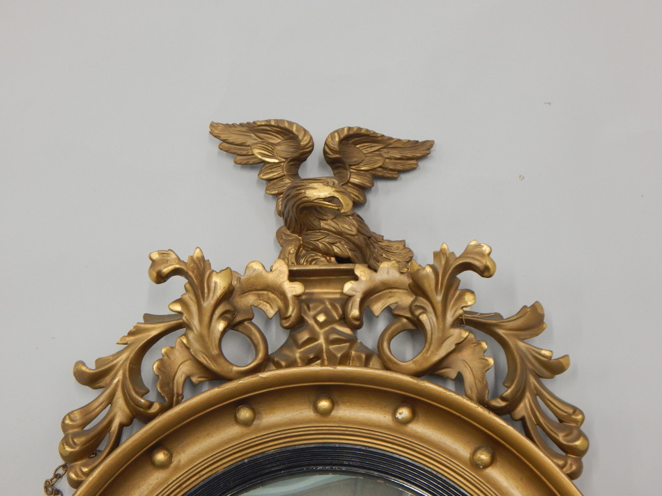 A Regency giltwood and gesso convex wall mirror, mounted with an eagle and foliate scroll crest, the - Image 2 of 3