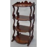 A Victorian walnut four tier whatnot, with a three quarter gallery on shaped supports and scroll