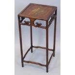 An early 19thC Chinese hardwood torchere or urn stand, with a circular top above a pierced and