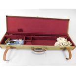 A canvas shotgun case, with a fitted interior, containing some cleaning equipment, 82cm wide