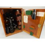 A Brooke Troughton & Sim microscope, with 17X magnification, ebonised metal in hardwood carrying