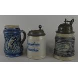 Three German stoneware beer tankards, each with incised decoration, two bearing a motto and with