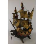 A carved and painted wooden three mast galleon, on a trestle type stand, (AF), 58cm high (M)
