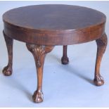 A figured walnut coffee table, the circular quarter veneered top with a crossbanded edge, on shell