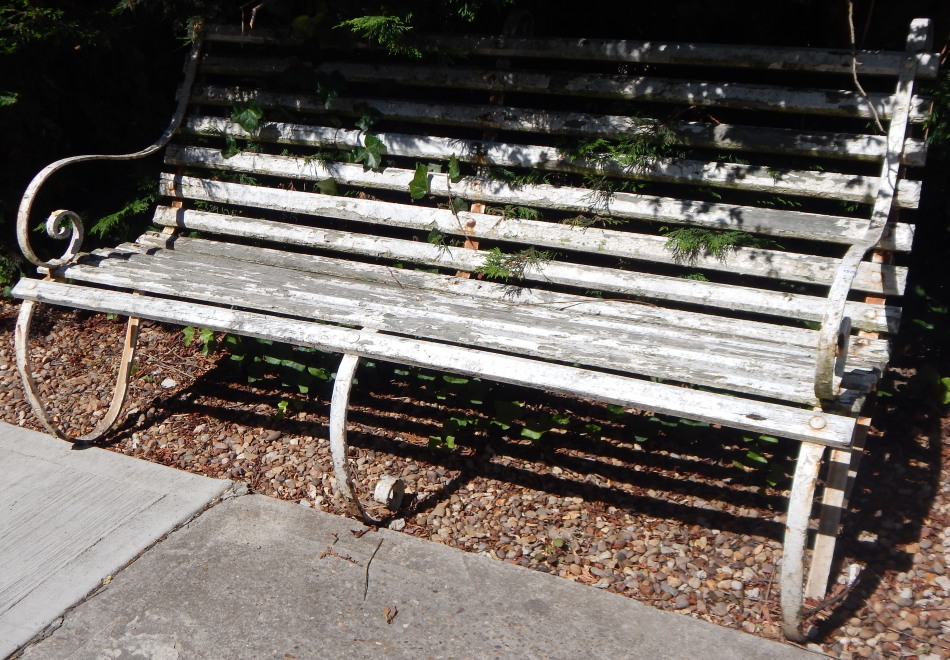 A late 19thC railway or park type bench, with three wrought iron supports and white painted