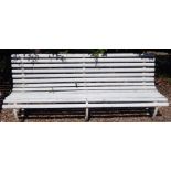 A late 19thC railway or park type garden bench, with three wrought iron supports and a white painted