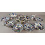 A mid 19thC Staffordshire part tea service, printed and painted in oriental style with figures, to