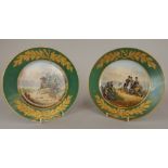 A pair of French sevres style porcelain plates, each painted with a battle scene within a green