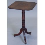 A mid 19thC occasional table, the rectangular top with canted corners, on a turned column and tripod