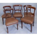 A set of five Victorian mahogany railway related dining chairs, each with a brown leatherette padded