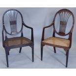 A near pair of late 19th/early 20thC open armchairs, each with a pierced splat and a cane seat, on