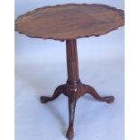 A 19thC mahogany adjustable occasional table, the shaped later dished top on a reeded turned