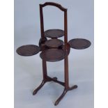 An early 20thC mahogany Monoplane adjustable cake stand, with patent ivorine label (M)