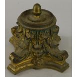 A gilt metal inkwell, modelled in the form of a Corinthian capital, with a brass stopper, 10cm