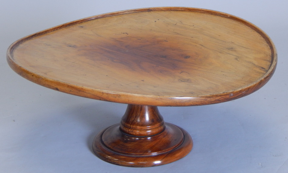 A late 19th/early 20thC walnut lazy Susan, the circular dish top on a revolving colun and domed