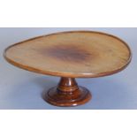 A late 19th/early 20thC walnut lazy Susan, the circular dish top on a revolving colun and domed