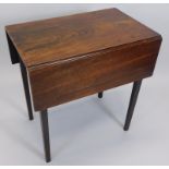 A George III mahogany Pembroke table, the rectangular top with two drop leaves on square tapering