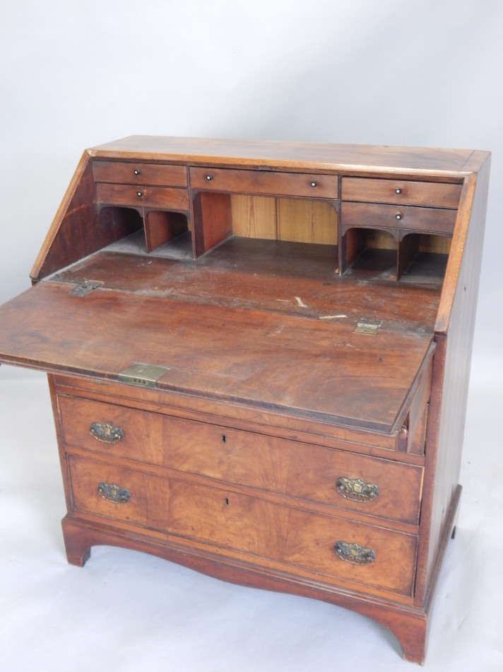 A George III mahogany bureau, the fall enclosing a fitted interior, above four graduated drawers, on - Image 2 of 2