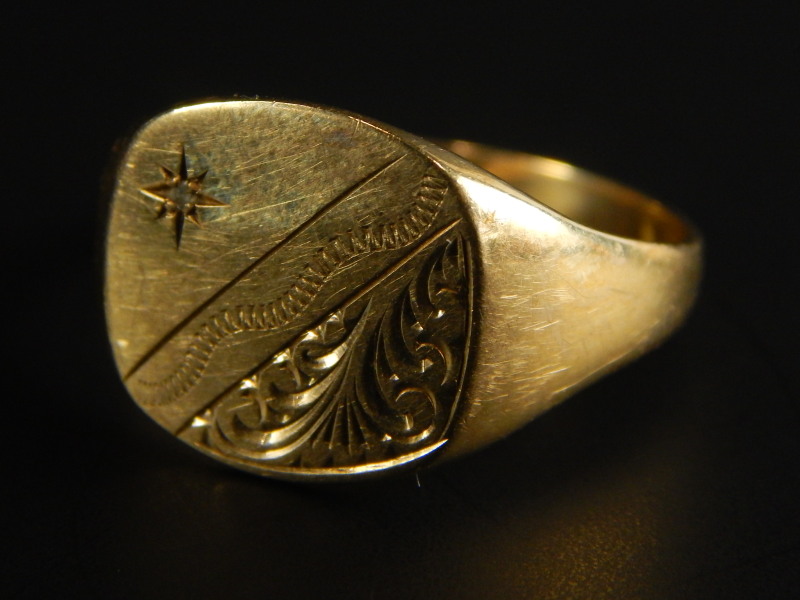 A 9ct gold signet ring, set with tiny white stone, and engraved shield, 3.3g all in.