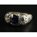 A Russian sapphire and diamond ring, with central sapphire approx 1.5cts, flanked by two old cut