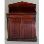 A Victorian mahogany chiffonier, the arched raised back, with a shelf on 'S' shaped supports, the