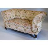 A late Victorian mahogany drop arm Chesterfield sofa, upholstered in plush fabric on turned and