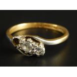 A three stone dress ring, set with two tiny diamonds (one stone missing), yellow metal, marked