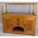 A late 19thC oak sideboard, the raised top on square tapering legs, the base with an arrangement