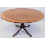 A 19thC mahogany breakfast table, the oval top with a crossbanded border, on a turned column and