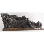 A Continental oak carving, depicting a reclining gentleman, possibly 17thC, 70cm wide.
