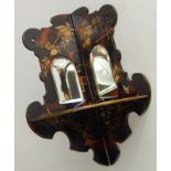 A Victorian papier maché wall bracket, printed in the Oriental style to simulate tortoiseshell,