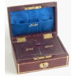 A burgundy leather travelling jewellery box, the domed lid part stencilled and worked to reveal a