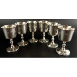 A set of six Elizabeth II silver goblets, each with a tapering bowl, turned column and domed foot,