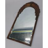 A walnut wall mirror in mid 18thC style, the shaped crest applied with a shell, etc., with a