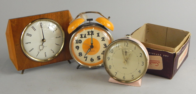 Three retro style clocks, to include a Westclock of Scotland, yellow and brown example.