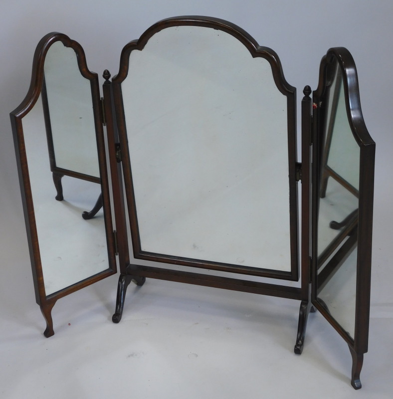 An early 20thC walnut triple mirror, with three arched plates on shape supports, 84cm wide.