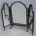 An early 20thC walnut triple mirror, with three arched plates on shape supports, 84cm wide.