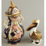 Two items of ceramics, a Royal Crown Derby brown porcelain pelican, with gold button and a Mason's