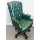 A green leather swivel office chair, with a padded back and seat.