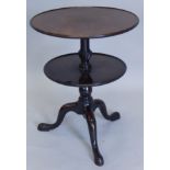 A mahogany dumb waiter, with two circular dished sections, on turned column and tripod base,